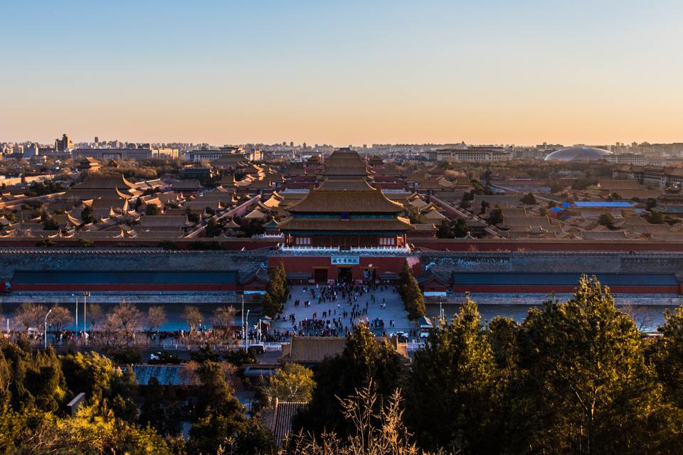 The golden roofs of the Forbidden City seen from Jingshan Hill at sunset, with the Gate of Divine Prowess in the centre.