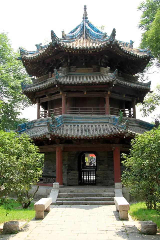 The octagonal, three-eaved Xingxin Tower of the Great Mosque of Xi'an, framed by trees.